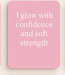 Pink square with white text 'I glow with confidence and soft strength'